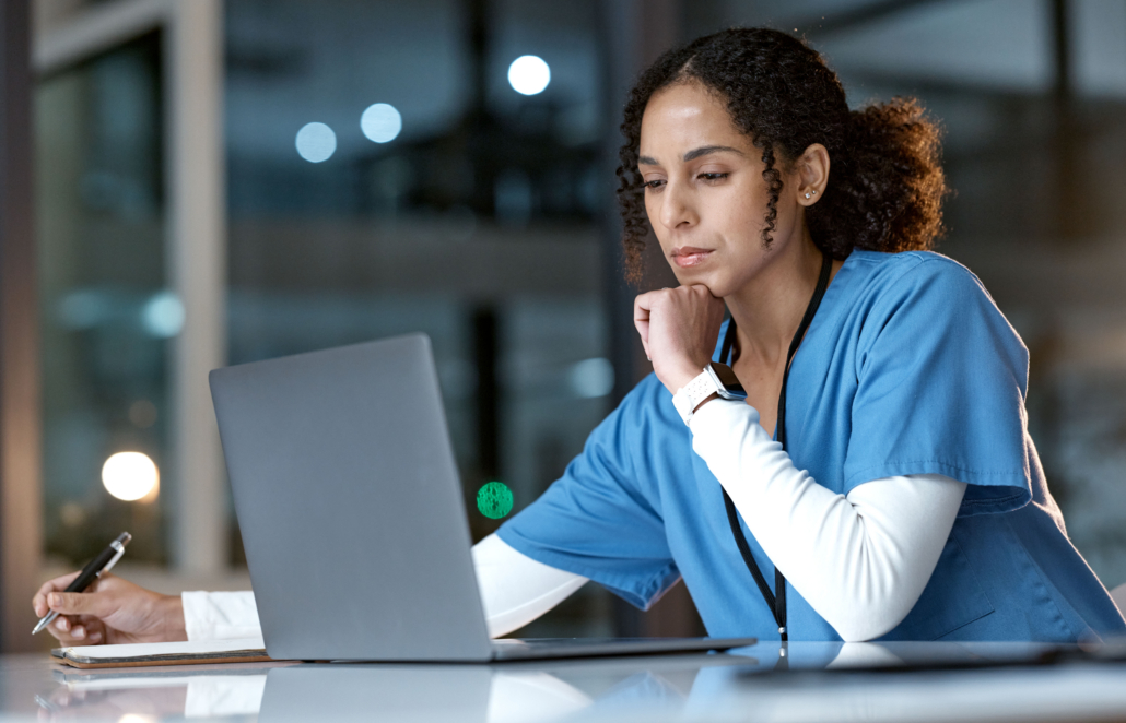 Nurse looking at her laptop studying via an online course